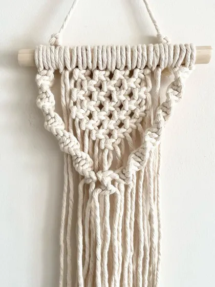 A closer look at one of the mini wall hangings from the set of three. This one features a heart-like shape made with spiral knots.