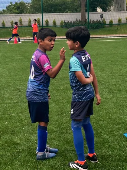 A candid moment between two young players during a weekend training session. Our program is just as much about building social skills and friendships as it is about football.