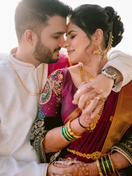 An intimate, sun-drenched portrait of the couple, highlighting their connection and traditional attire.
