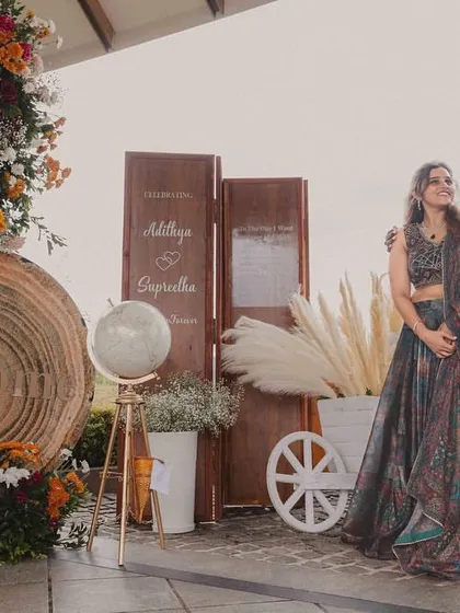 The couple posing by the personalized welcome station we designed. This setup not only greeted guests but also shared a piece of their story, making the event more intimate.