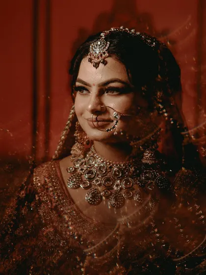 An artistic bridal portrait using a slow shutter speed to create a dreamy, ethereal effect around the bride.