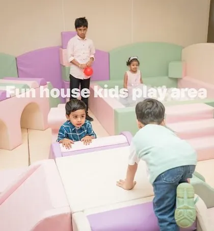 Children of various ages enjoying the different elements of the pastel play area, from climbing to exploring.