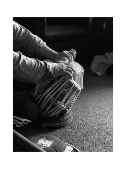 A black and white shot focusing on my hands on the tabla. This captures the physical act of creating rhythm, where the hands become an extension of musical thought.