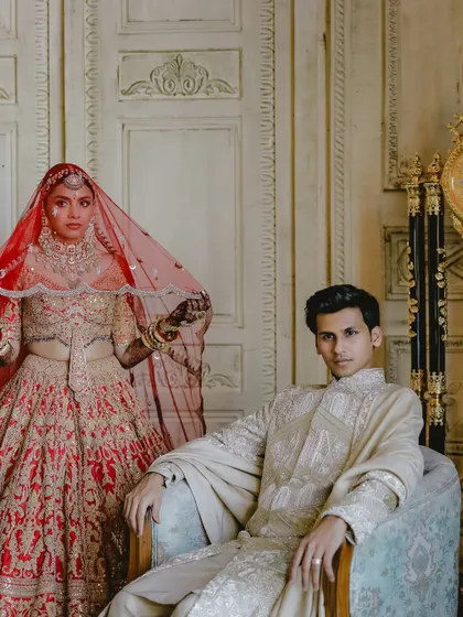 The King and his Queen. A powerful, editorial-style portrait that showcases the couple's regal presence and the stunning detail of their outfits.