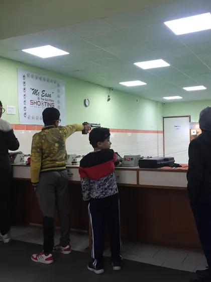 Young shooters learning the fundamentals of pistol shooting at the range.