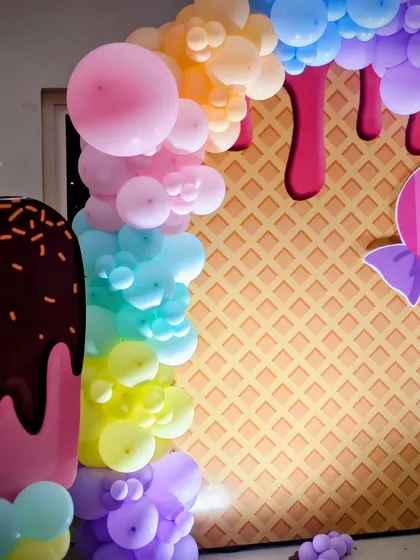 A photo-op corner with a waffle-print backdrop and giant ice cream cutout, perfect for capturing sweet memories.