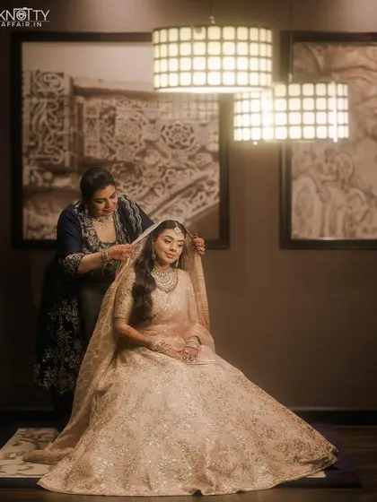 A beautiful moment of the bride getting her dupatta set, captured with soft, elegant lighting.