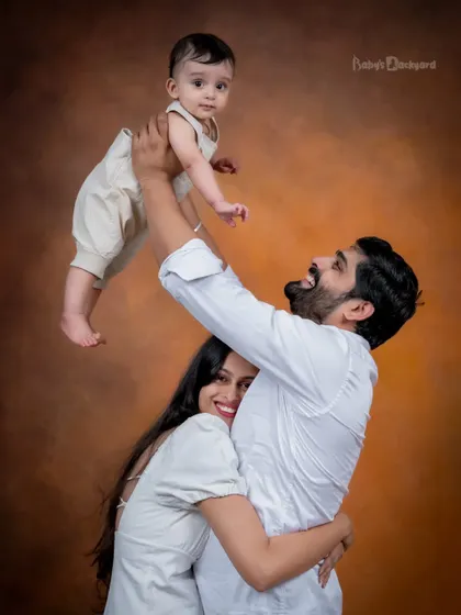 In our arms and forever in our hearts. A classic family pose filled with so much love and happiness.