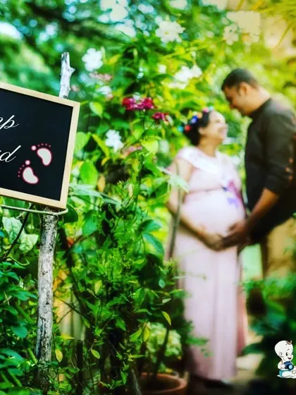 Using creative props like this "Bump Ahead" sign adds a fun and whimsical element to the photoshoot. It creates a playful memory while the couple shares a moment in the background.