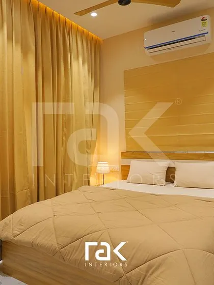 A simple and calming bedroom with a monochrome beige color scheme, from the curtains to the bedding.
