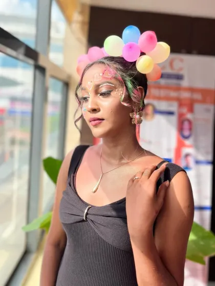 A whimsical look featuring a headpiece made of balloons and sparkling face gems. My courses encourage students to think outside the box and use unconventional materials.