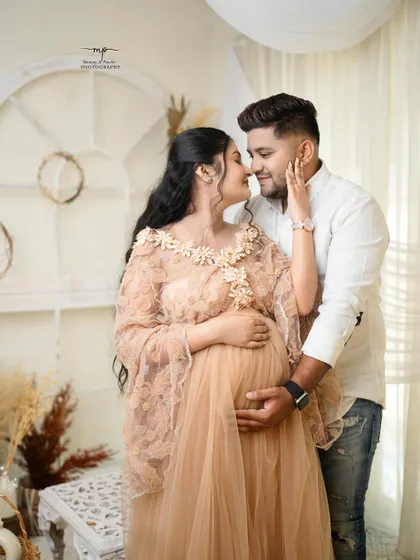 Our love multiplied. This intimate pose, with the couple nose-to-nose, is full of tenderness and joy. A perfect shot from their boho-chic maternity session.