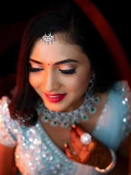 A close-up on the eyes. This shot beautifully captures the shimmery lid, defined lash line, and perfectly groomed brows of her reception makeup.