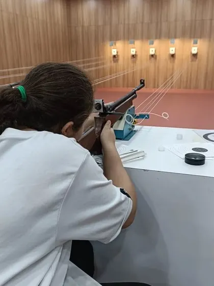 A first-time shooter learns the proper form for aiming an air rifle. We ensure every beginner starts with a solid foundation, focusing on stance, breathing, and trigger control.