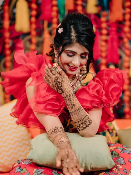 The intricate details of the bride's henna stand out against the colourful decor. I always aim to create a backdrop that complements the bride's attire and the ceremony's traditions.