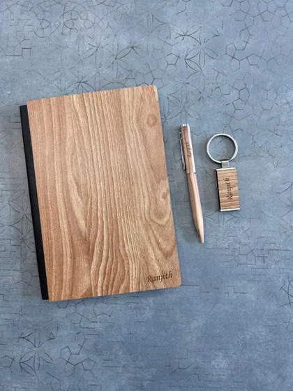 This simple yet elegant set features a light-wood diary and keychain personalized for "Ramith", along with a matching pen. It's a great example of a minimalist and personal wooden gift.