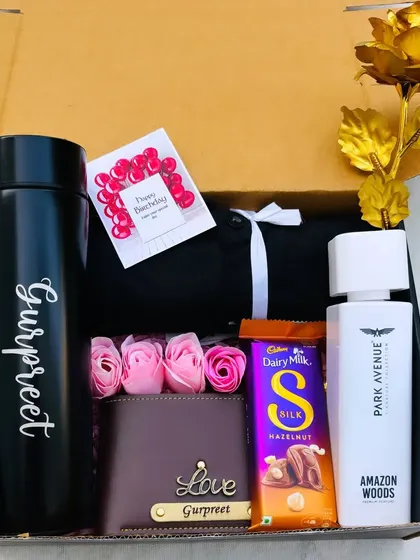 A beautifully arranged hamper for him, featuring a personalized temperature bottle and wallet, a shirt, perfume, and a golden rose for a touch of elegance.