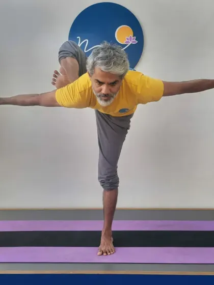 This is a variation of Utthita Hasta Padangusthasana, a standing balance pose that challenges stability and hamstring flexibility. My practice focuses on maintaining alignment and drishti, or focused gaze, which I teach as essential elements for balance.