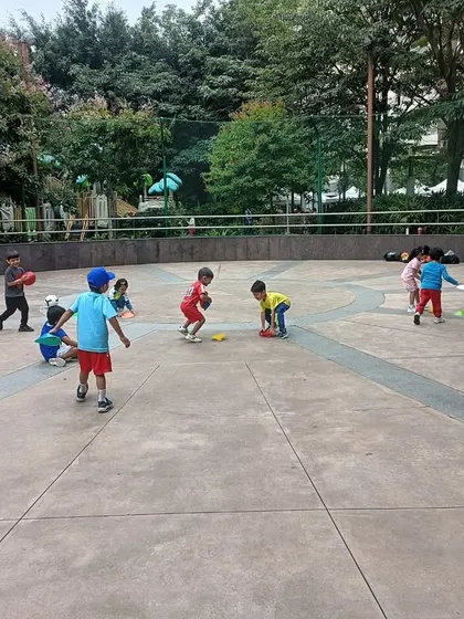 A wide shot of our toddler football class in an apartment complex, showing how we make sports accessible and fun.