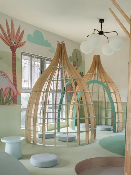 A detailed shot of the beautifully crafted wooden reading pods. Their organic shape and natural material bring a sense of warmth and tranquility to the library space.