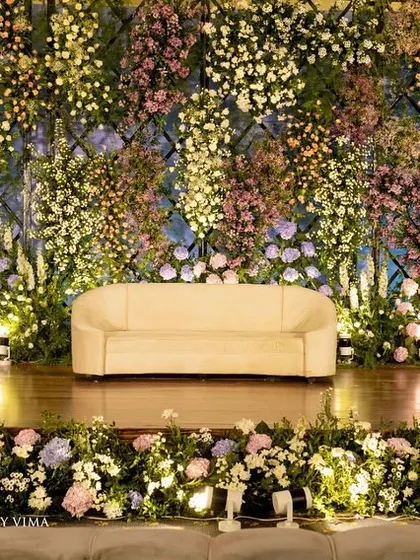 For this reception, we created a breathtaking backdrop with a wall of lavender and pastel florals. The strategic arrangement of hydrangeas, roses, and baby's breath created a magical and enchanting photo wall.