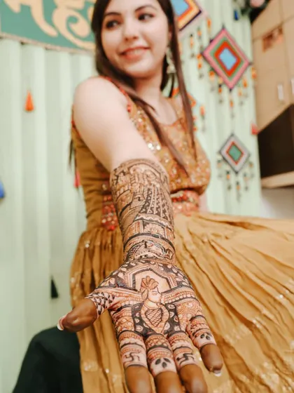 A different angle, focusing on the beautiful peacock and figure work on her palm.