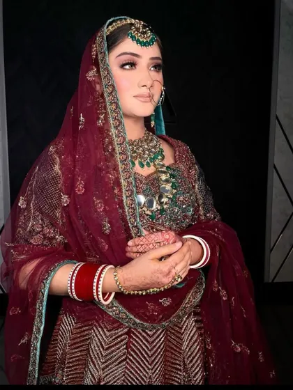Another angle of the bride, showcasing the rich colours of her outfit and jewellery.