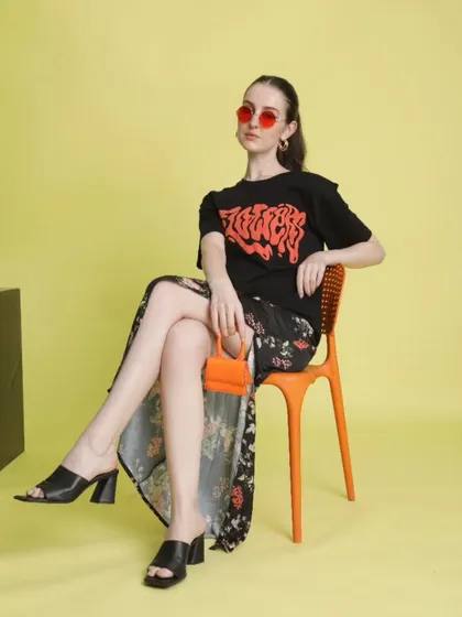 For the women's 'Chic Street' line, I mixed edgy with feminine. This look combines a graphic tee with a floral slit skirt, black mules, and a mini orange bag for a surprising and stylish contrast.