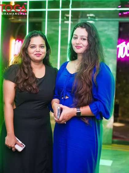 A stylish pair of friends enjoying the party and the great music.