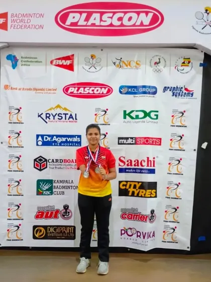 **Double Silver in Uganda.** Our para-athlete Latika proudly displays her two silver medals from the Uganda Para Badminton Tournament 2024, competing in both Women's Singles and Women's Doubles.