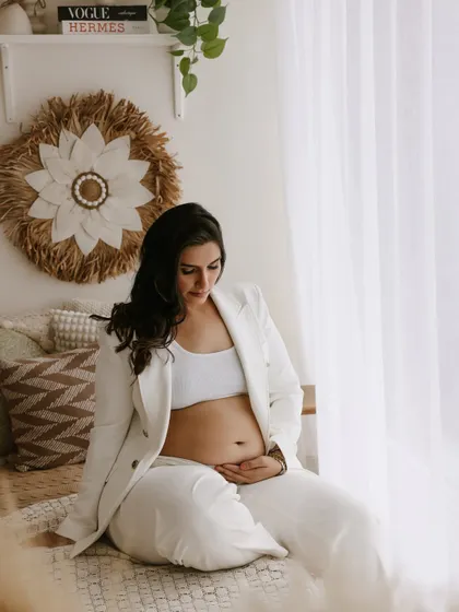 A modern take on maternity style. This mom-to-be looks powerful and chic in a white blazer, showing that maternity fashion can be both comfortable and confident.
