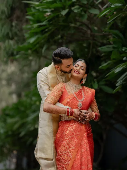 A quiet, intimate portrait framed by lush greenery. We use natural elements to create a sense of romance and tranquility in our couple's wedding photos.
