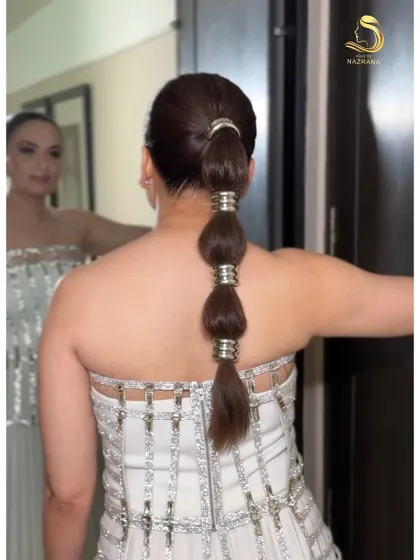 Fun, chic, and totally on-trend. This bubble braid, accented with metallic rings, is a playful yet polished look that’s guaranteed to make a statement at any party or sangeet.