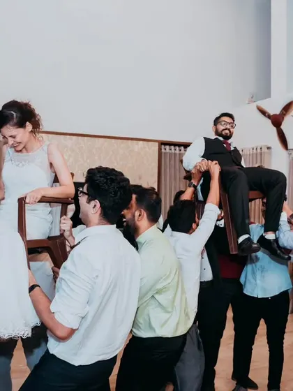 The entire group enjoying the lively Hora dance, a testament to the fun and energy of this interfaith wedding celebration.