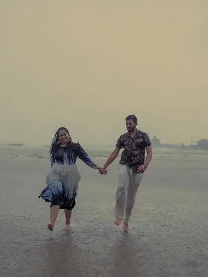 Hand-in-hand, running through the rain. This candid shot from a monsoon pre-wedding in Goa is all about capturing the energy and spontaneity of the moment.