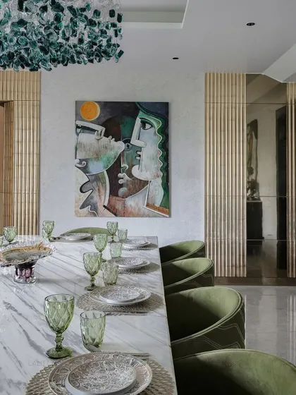 A view of one of our elegantly styled dining rooms. We focus on combining statement lighting, comfortable seating, and high-quality materials like marble and brass to create spaces that are perfect for both everyday meals and special occasions.