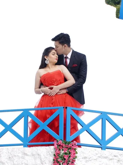A beautiful silhouette of the couple on a bridge. This pre-wedding shot uses the setting to create a romantic and picturesque memory.