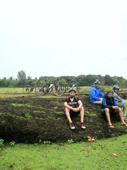 Taking a break on a rocky outcrop amidst the green fields of Gokarna. Our tours are about enjoying the journey and the company of fellow riders.