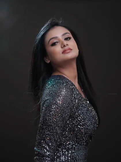 A high-fashion portrait with a focus on attitude. The lighting and pose are crafted to create a look that is both strong and elegant, suitable for fashion editorials.