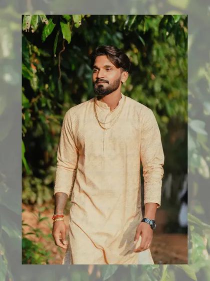 A portrait of the groom in his traditional attire for the Haldi ceremony, looking relaxed and happy.