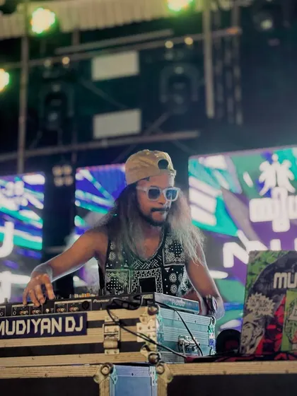 A cool, confident shot of me at the DJ booth, wearing sunglasses and ready to mix.