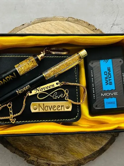 A closer look at a personalized Rakhi gift set. This combo includes a wallet, pen, keychain, and bracelet, all customized with a name and presented on a wooden slice.