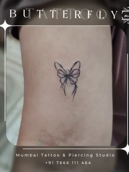 A still image of the elegant ribbon butterfly tattoo. The fine lines and minimalist style make it a subtle yet beautiful piece of art on the upper arm.