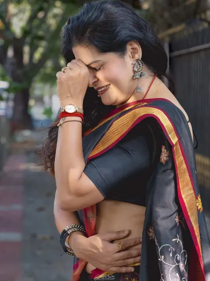 A candid, laughing shot in the same saree. This shows that even elegant, traditional outfits can be worn with a sense of ease and joy.