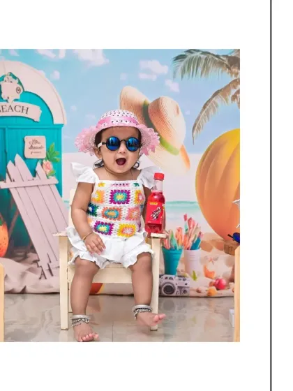 A fun, expressive shot from the beach-themed portrait session. The wide-eyed, open-mouthed expression of joy is what makes these photos so special.