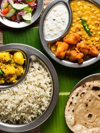 A simple, traditional meal served on a banana leaf for that authentic touch. This thali includes rice, aloo gobhi, a lentil dish, cooling raita, and soft chapatis, just like 'maa ke haath ka khana'.