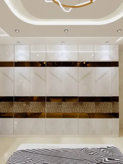 A full view of a spacious bedroom, highlighting the large, high-gloss wardrobe with a geometric gold and marble pattern. The design is clean, luxurious, and offers ample storage.