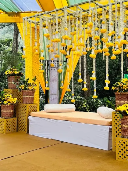 A side view of the Haldi seating, showing the tiered arrangement of sunflower baskets and the intricate lattice-work props.