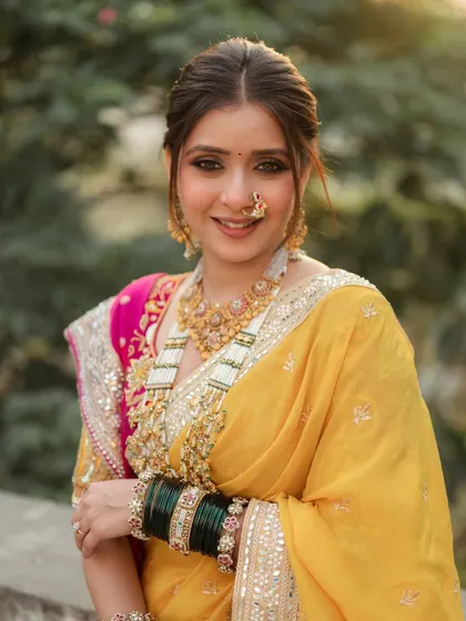 Painted with poise and adorned with pride. This look features classic kohl-rimmed eyes and a flawless base, set against a beautiful yellow saree. It’s a timeless Maharashtrian bridal style that is both bold and meek.