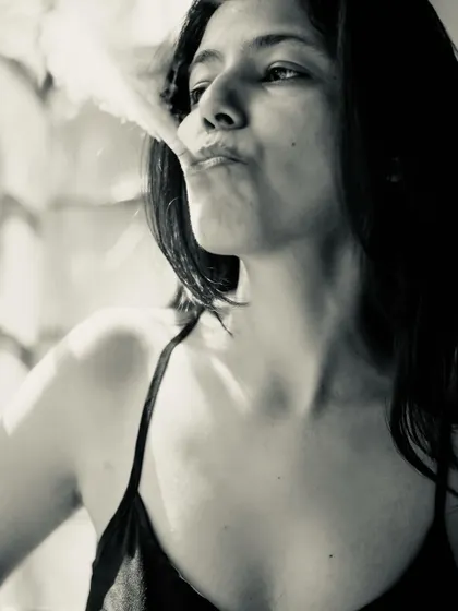 A dramatic black and white portrait with smoke, creating an edgy, cinematic character. I don't smoke, but I do what it takes to create a vibe.